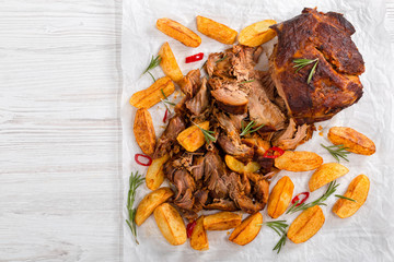 pulled slow-cooked pork grilled in oven with fried potato