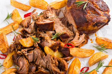 pulled slow-cooked meat grilled in oven with fried potato wedges