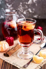 Mulled wine in a glass on wooden background