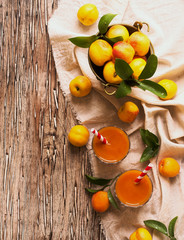 Fresh apricot juice in glass on wooden table, selective focus