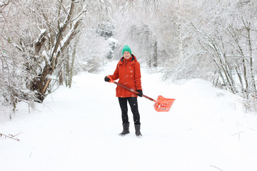 Young woman shoveling rural road