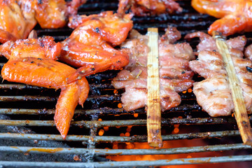  grill pork and chicken wing on bbq flaming grill