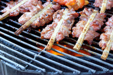  grill pork and chicken wing on bbq flaming grill
