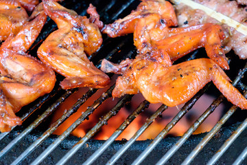  grill pork and chicken wing on bbq flaming grill