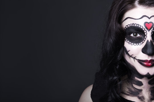 close up portrait of smiling woman with Halloween skull make up