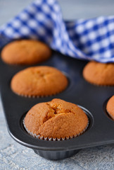 Homemade hot muffins in the form of a concrete background
