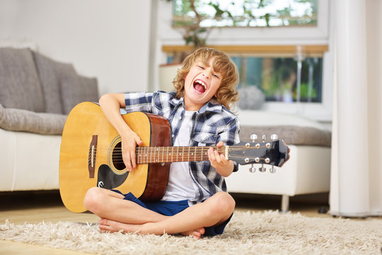 Boy having fun making music with guitar
