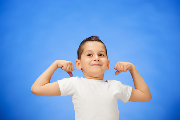 Beauty smiling sport child boy showing his biceps
