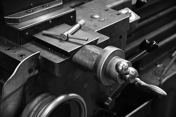 Obsolete lathe. Black-and-white photo.