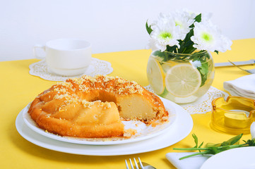 Yellow summer table setting with lemon bundt cake