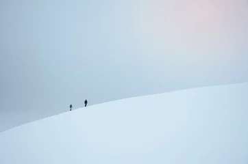 Gordijnen Two tourist walking in snowy landscape in norway. They travel to famous trolltunga rock © kovop58