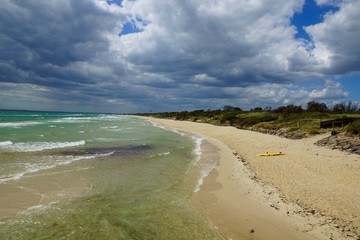endless beach stretch with lifesaving boat
