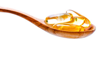 Spoonful of gel capsules of omega 3. Close up capsules fish oil