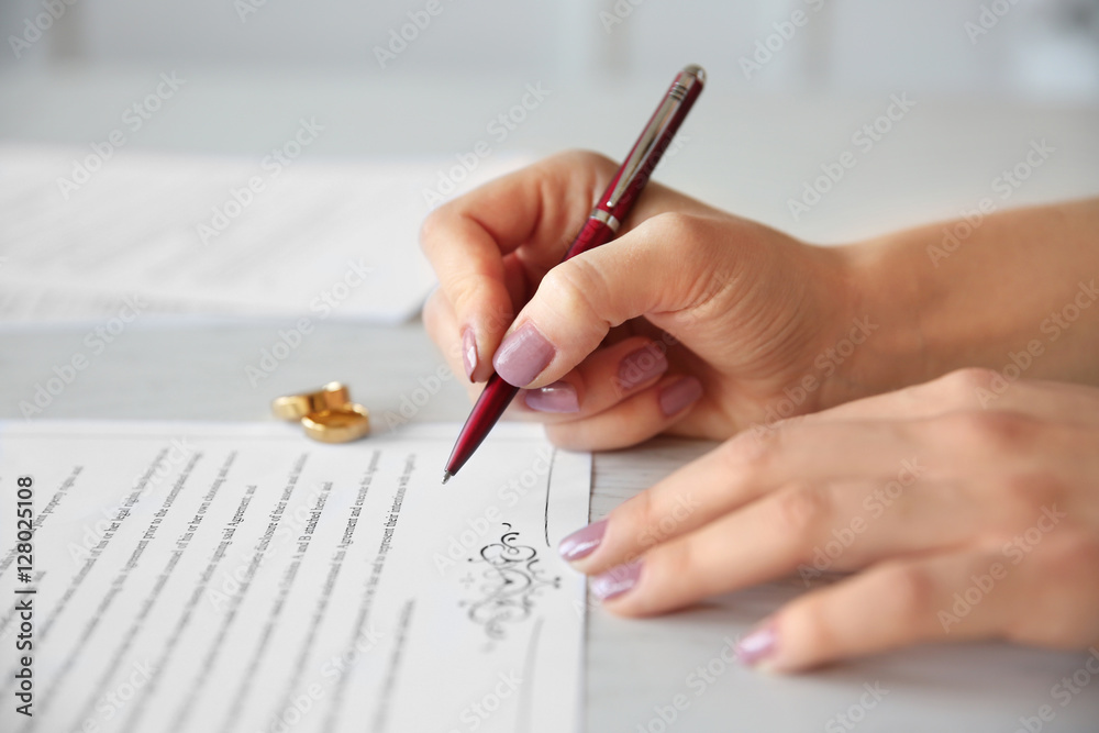 Wall mural woman signing marriage contract, closeup