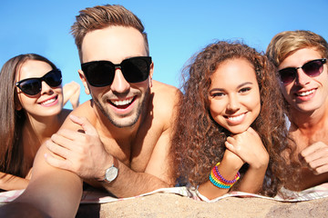Happy friends taking selfie on beach