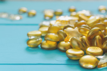 Close up image of yellow marbles on blue wooden background