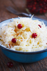 Salad of sauerkraut and carrots in rustic style. Selective focus.