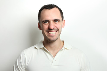 Fototapeta premium Portrait of a happy young man on a light background.