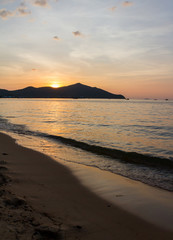 sun is sunset on mountain  can see on the beach