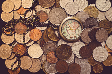 Time is money, a bunch of coins with a pocket watch on top, top