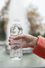 Bottle of water. Hand hold bottle mineral water.