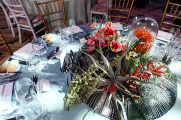 Exotic flowers stand on a silver tray decorated with crystals