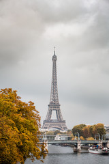 Obraz premium The Eiffel Tower, with cloudy autumn sky.
