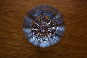 Look from above at wedding rings in a glass