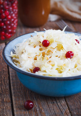 Salad of sauerkraut and carrots in rustic style. Selective focus.