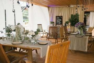 Cosy restaurant with white flowers on wooden tables
