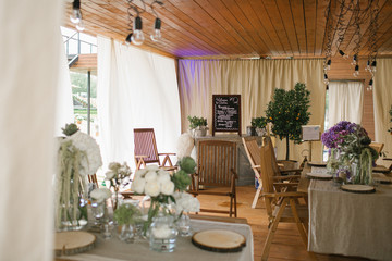 Cosy restaurant with white flowers on wooden tables