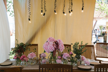 Black lamps hang over the wooden table