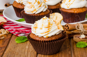 Carrot cupcakes with walnuts and butter cream on top
