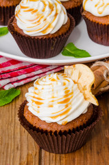 Carrot cupcakes with walnuts and butter cream on top