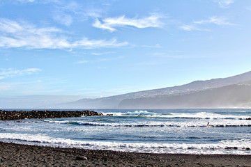 Black volcanic sand on the coast of the island of Tenerife, Spain
