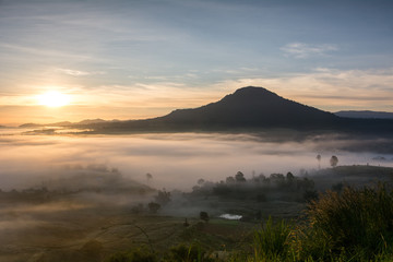 mist over the valley of mountain at sun rising giving a beautiful colour in the field