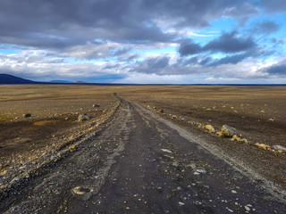 Traveling down the gravel road in desert, Kjolur Highland route F35 Volcanic Iceland