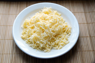 grated cheese on a white plate
