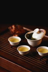Chinese tea ceremony. Tea set on tea desk chaban with golden frog.  Soft selective focus.