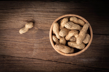 Peanuts in wooden bowl.