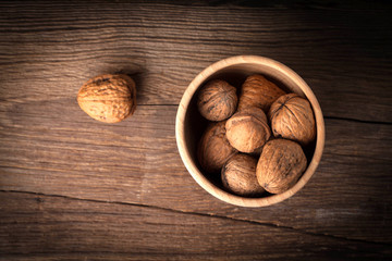 Walnuts in wooden bowl.