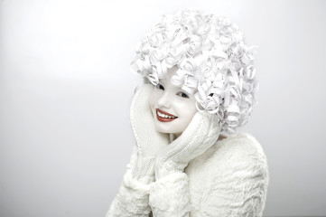 Portrait of a cute girl with a white face and curly hair..