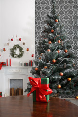 Christmas present in decorated room background, holiday concept