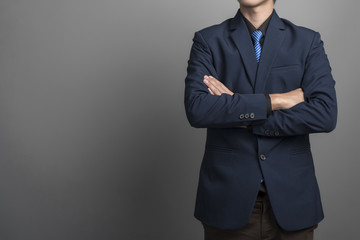 Obraz na płótnie Canvas Close up of businessman in blue suit confident on gray backgroun