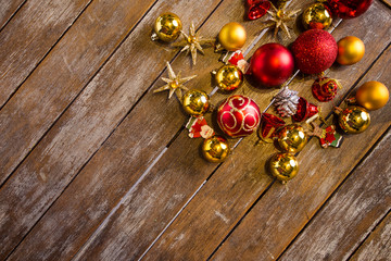 Shiny Christmas balls laying on a rustic table, ready to be hung