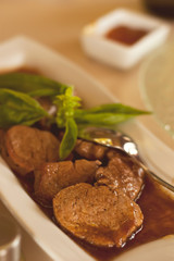 Veal medallions whith sauce and fresh basilic