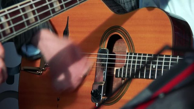 Men play on guitar - close up hands with guitar