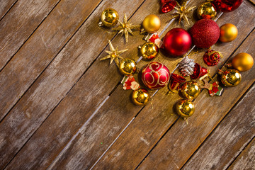 Shiny Christmas balls laying on a rustic table, ready to be hung