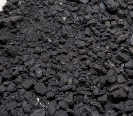 Black coal lying on a pile in house basement