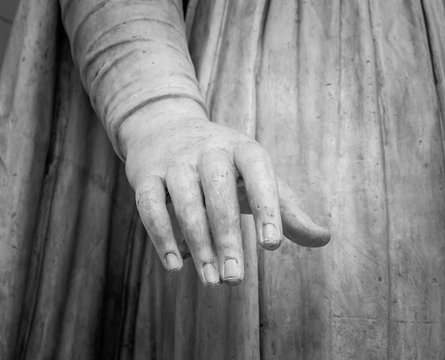 stone statue detail of human hand 